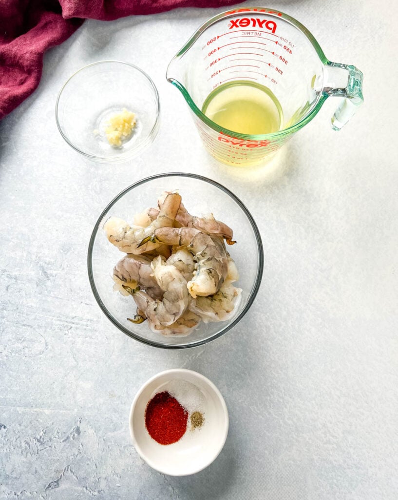 broth, garlic, shrimp, and spices in separate bowls