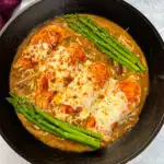 Cheesecake factory copycat chicken Madeira in a skillet with asparagus