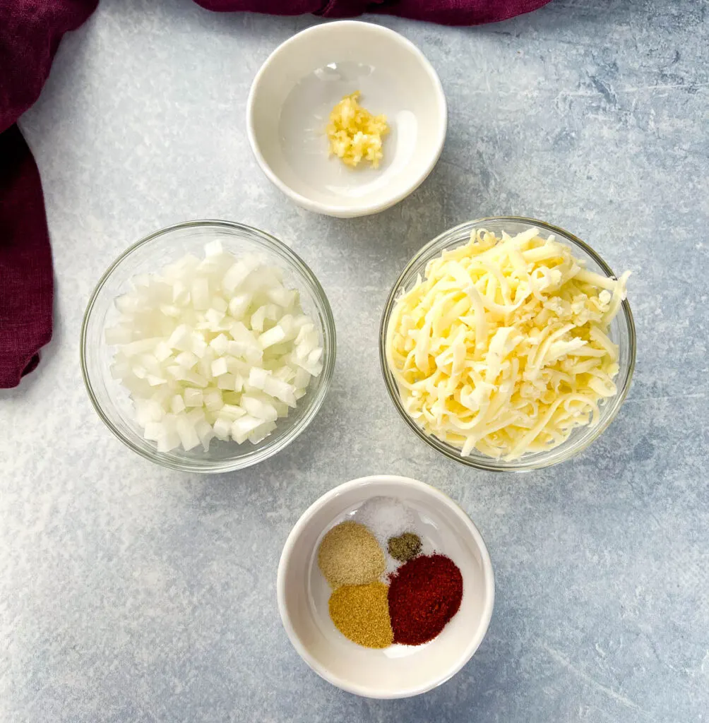 garlic, onions, mozzarella cheese, and spices in separate bowls