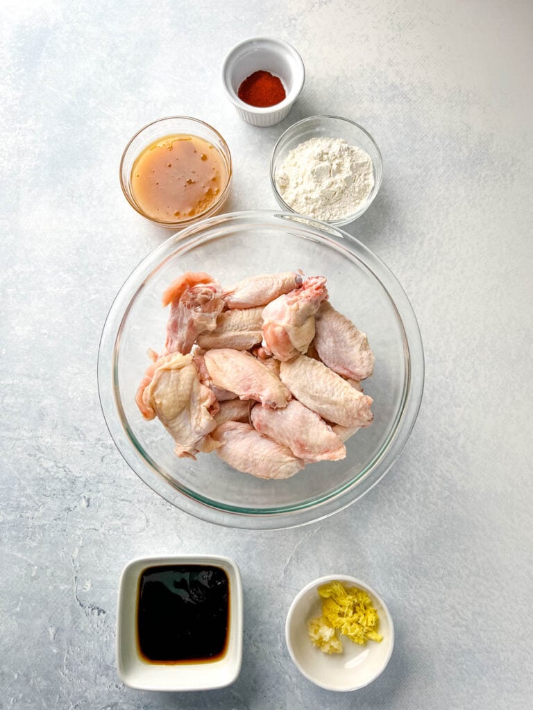 raw chicken wings, honey, garlic, soy sauce, and smoked paprika in separate bowls