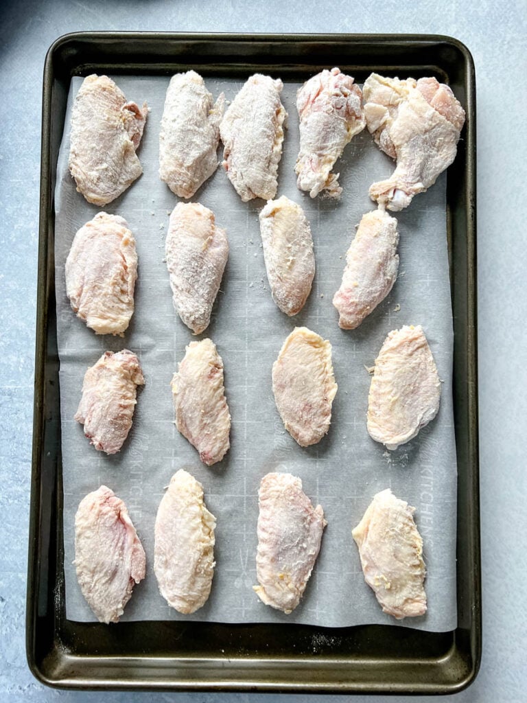 raw chicken wings on sheet pan