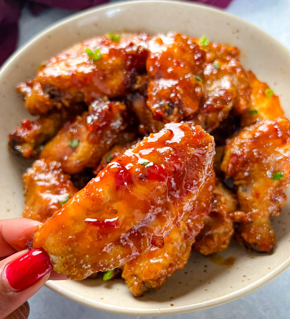 person holding sweet chili chicken wing