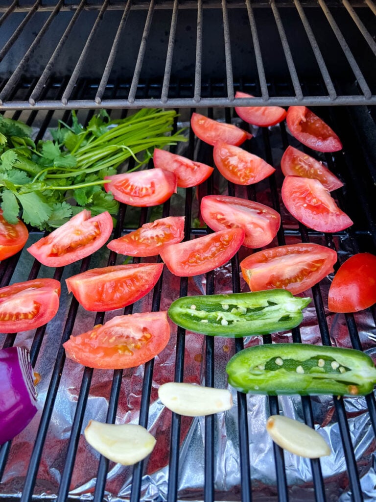 tomatoes, onions, cilantro, and garlic on a Traeger smoker