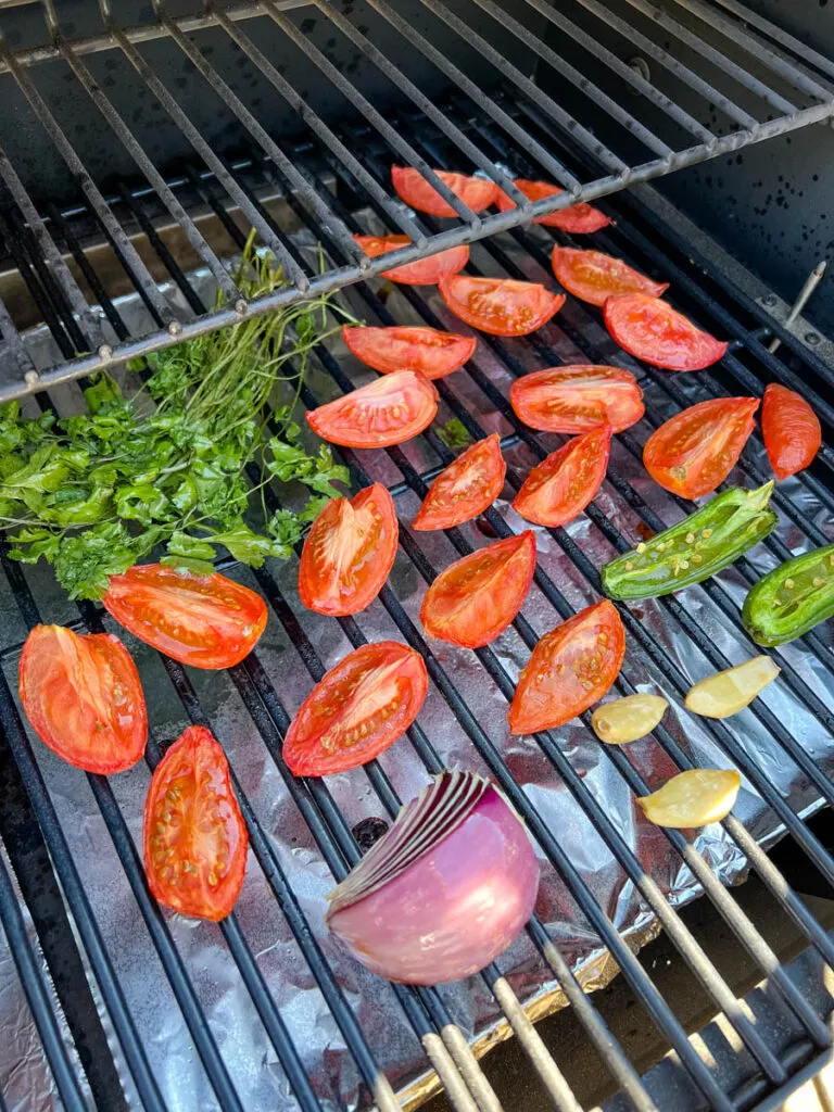 tomatoes, onions, cilantro, and garlic on a Traeger smoker