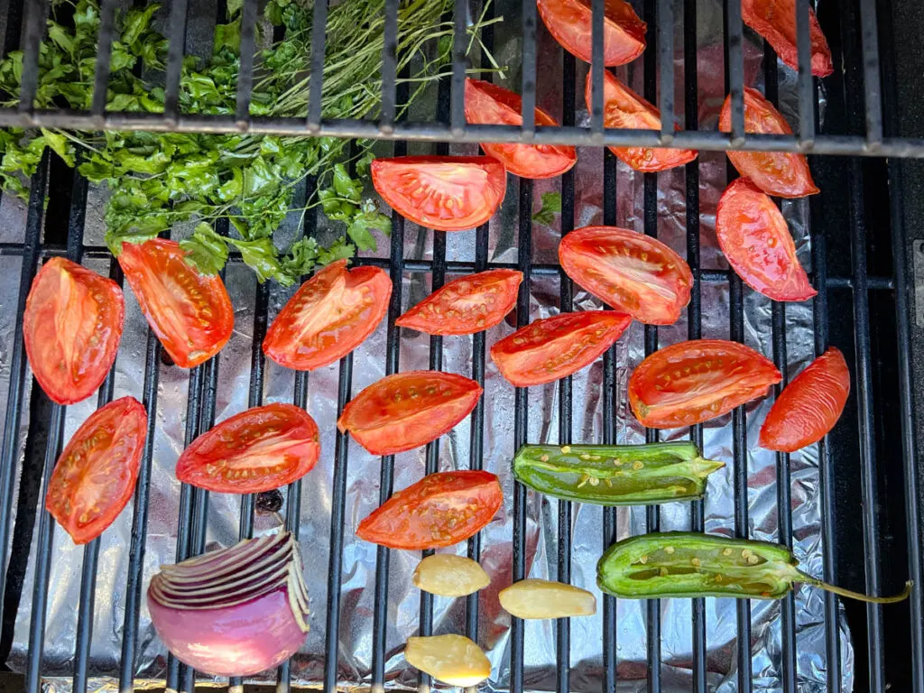 tomatoes, onions, cilantro, and garlic on a Traeger smoker