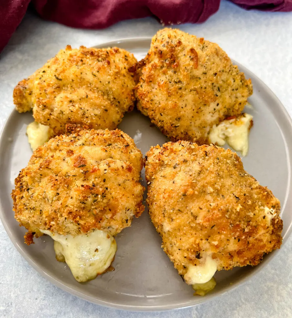 mozzarella stuffed chicken breasts on a plate