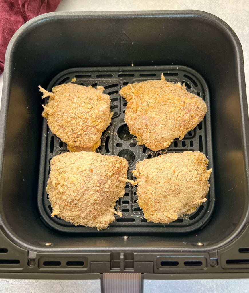 uncooked breaded stuffed mozzarella chicken breast in an air fryer
