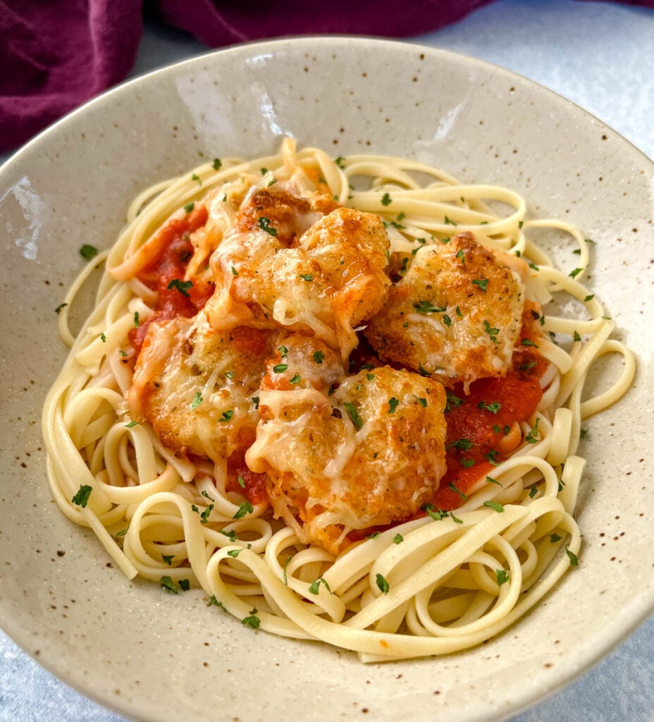 shrimp parmesan Parmigiana with mozzarella and pasta in a bowl