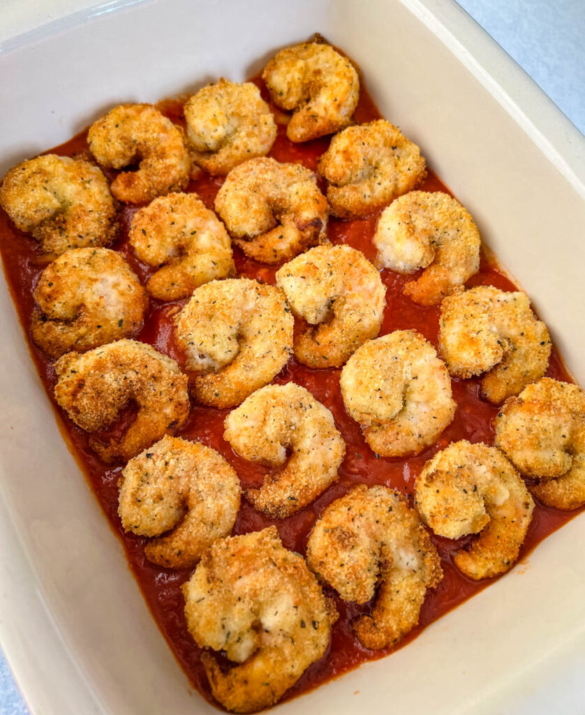 shrimp parmesan Parmigiana in a baking dish