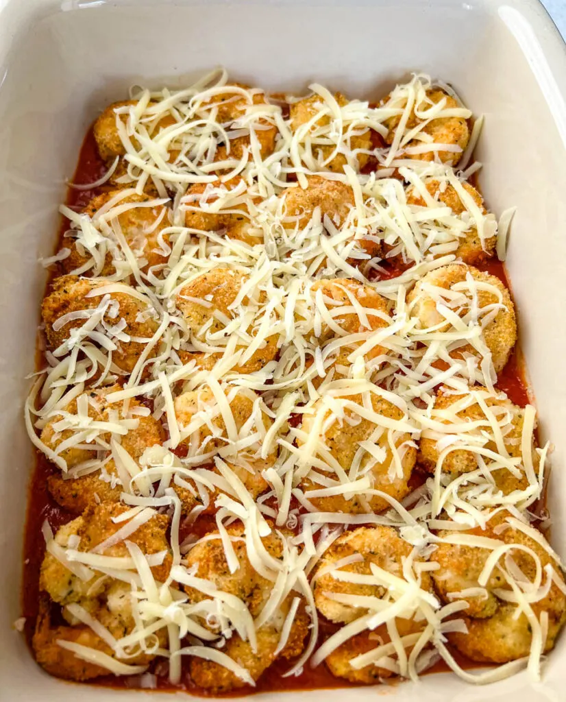 shrimp parmesan Parmigiana with mozzarella in a baking dish