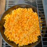 smoked mac and cheese in a cast iron skillet on a Traeger smoker