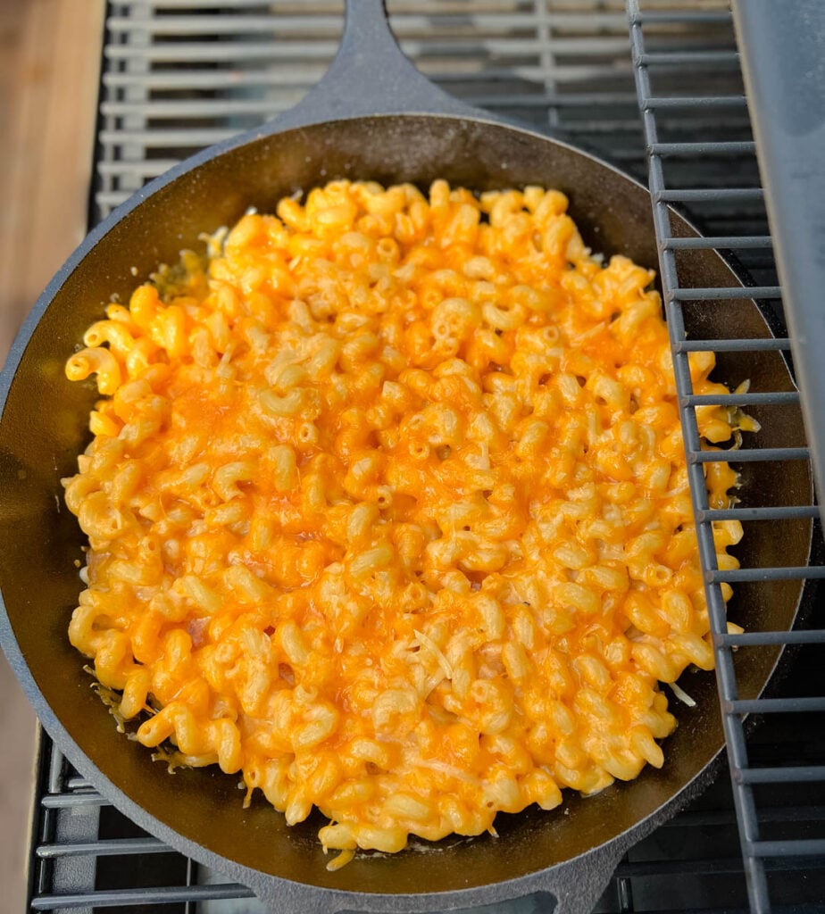 smoked mac and cheese in a cast iron skillet on a Traeger smoker