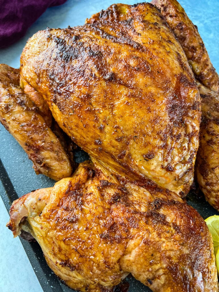 smoked turkey with lemons and parsley on a table