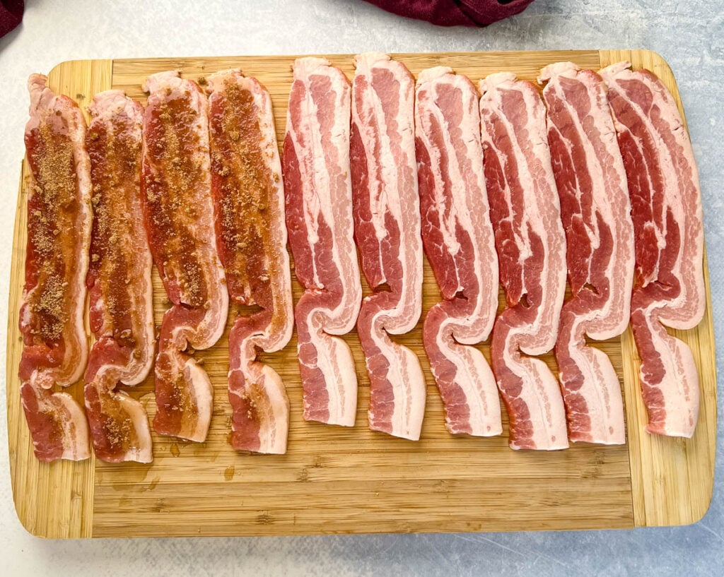 uncooked thick bacon on a cutting board