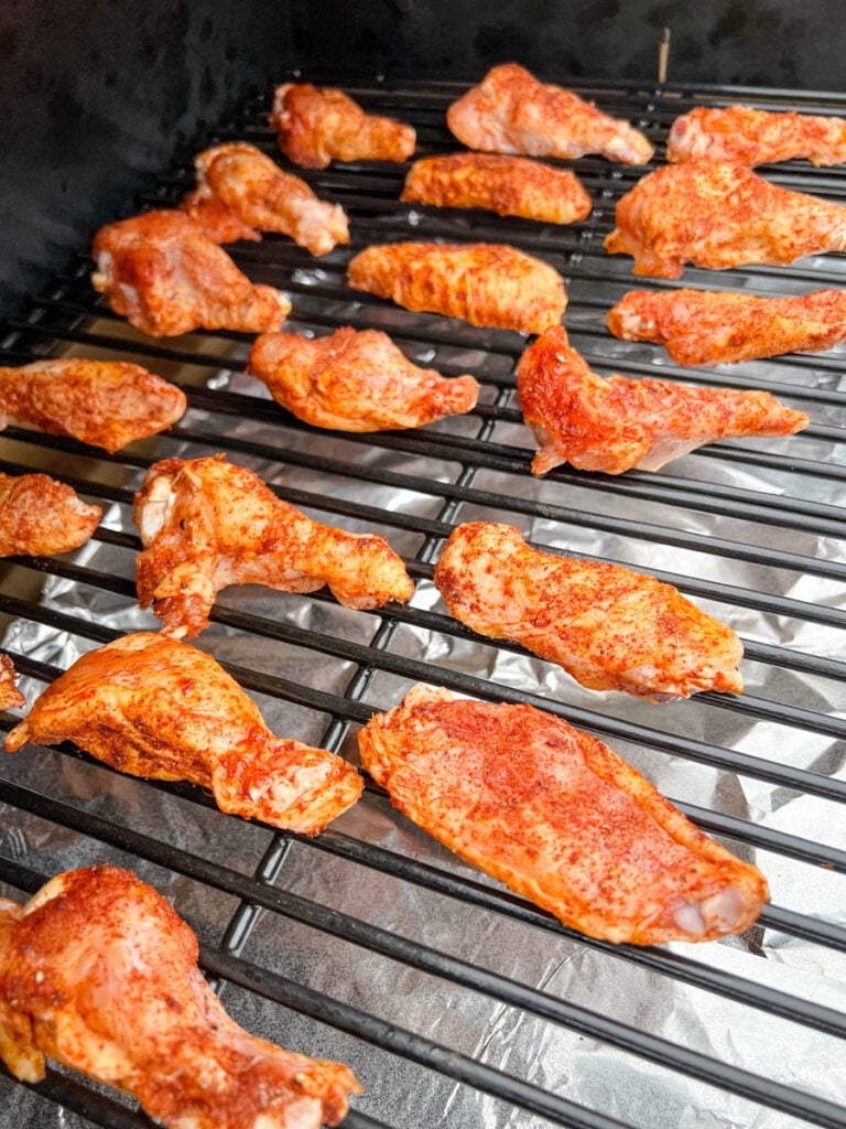 raw chicken wings on a Traeger smoker pellet grill