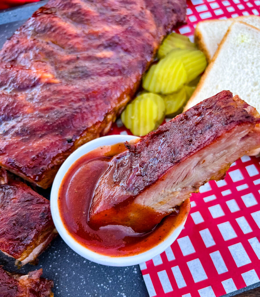 Traeger smoked rib dipped in BBQ sauce