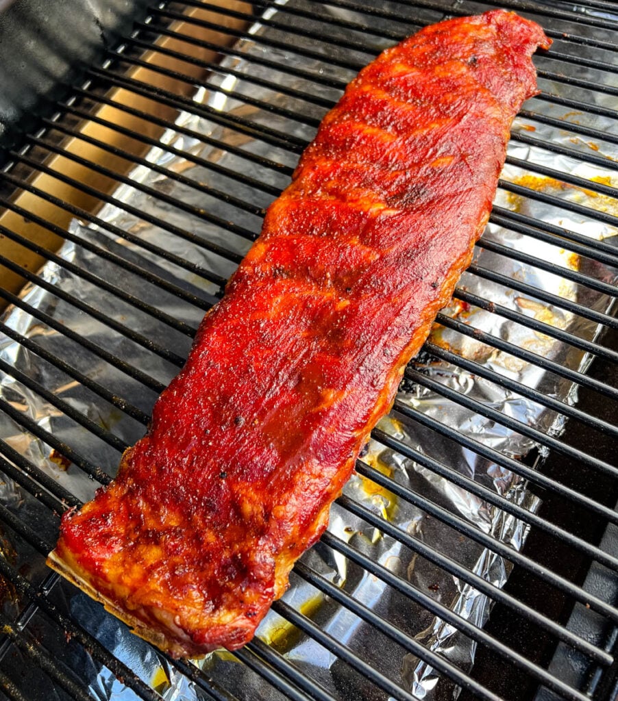 smoked rib on Traeger grill with BBQ sauce