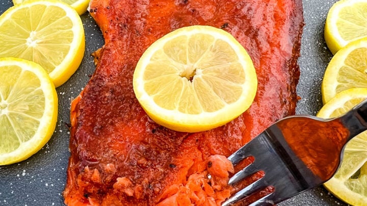 Traeger smoked salmon on a plate with fresh lemons