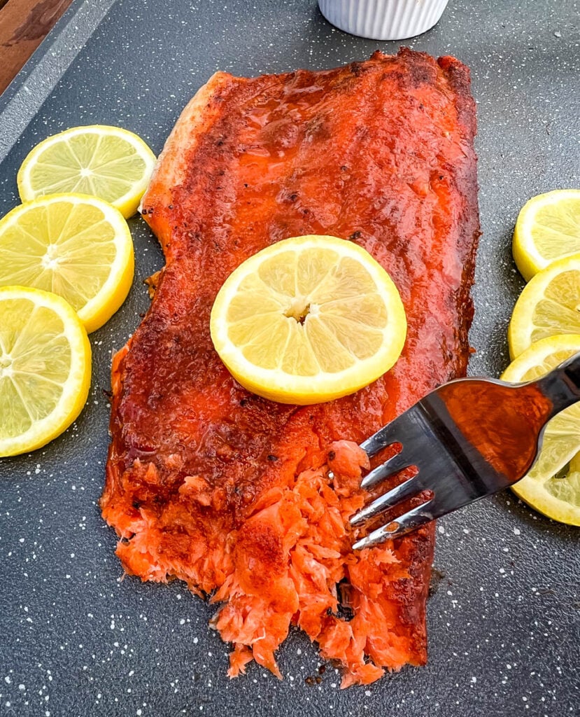 Traeger smoked salmon on a plate with fresh lemons