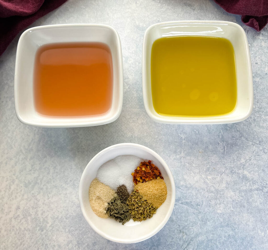 vinegar, olive oil, and spices in separate bowls