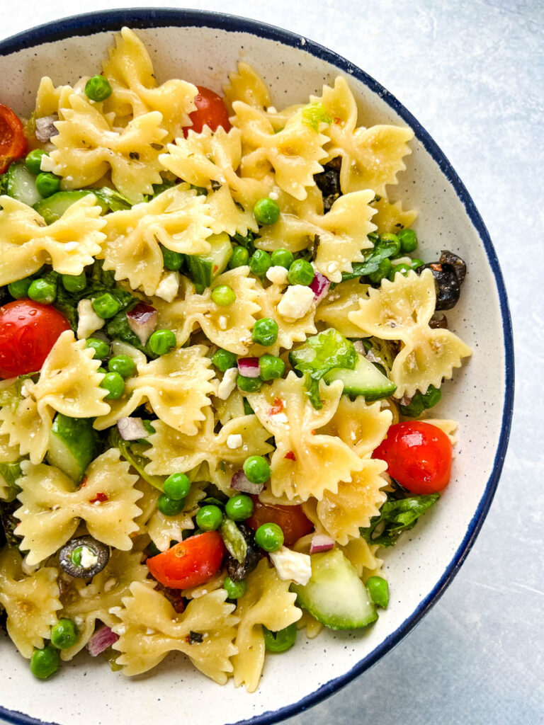 bow tie farfalle pasta salad with vegetables with Italian dressing in a bowl
