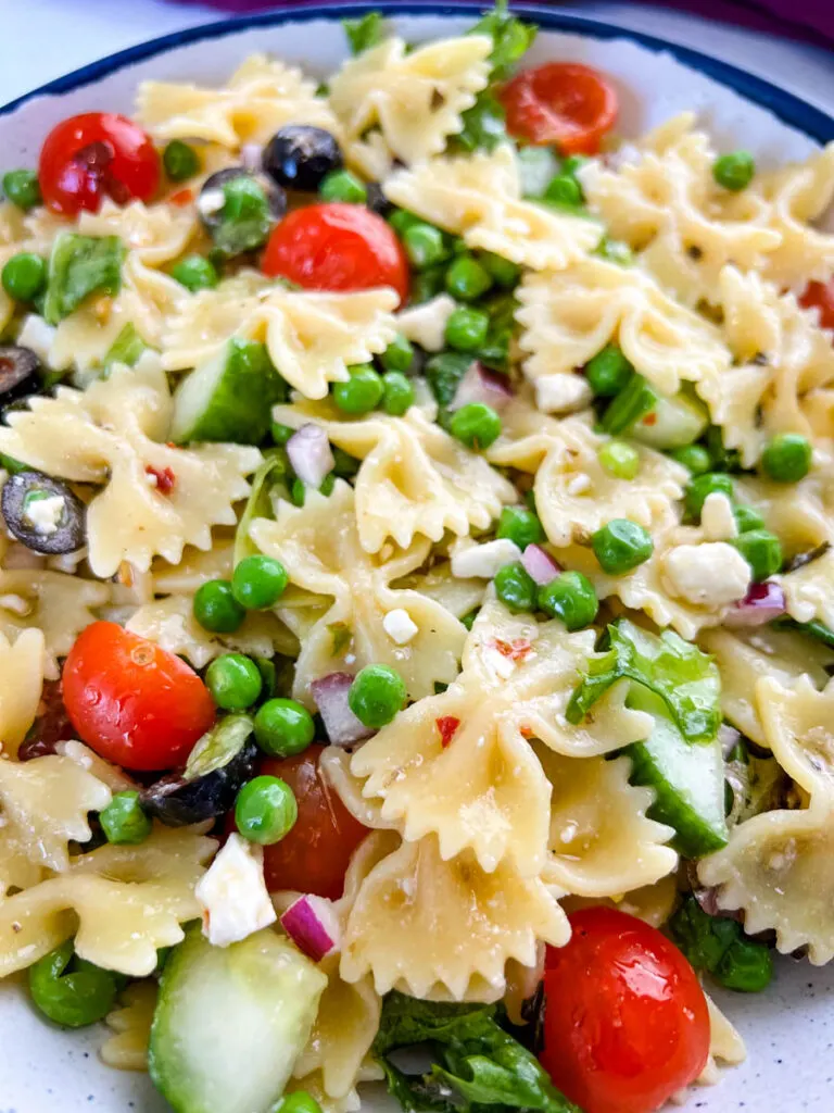 bow tie farfalle pasta salad with vegetables with Italian dressing in a bowl