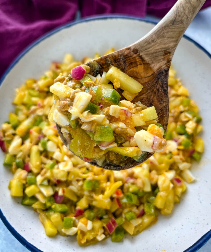 hot girl summer salad tiktok recipe in a white bowl with a wooden spoon