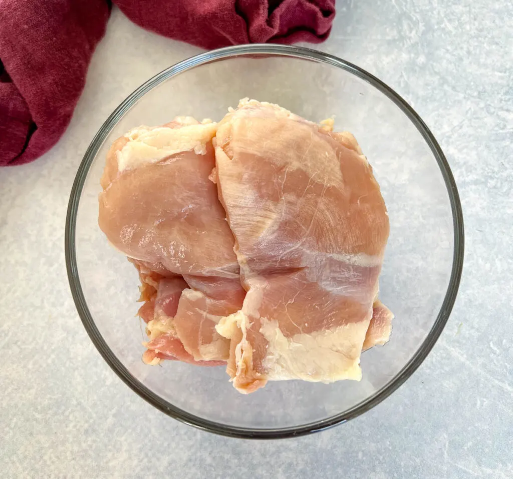 boneless skinless chicken thighs in a glass bowl