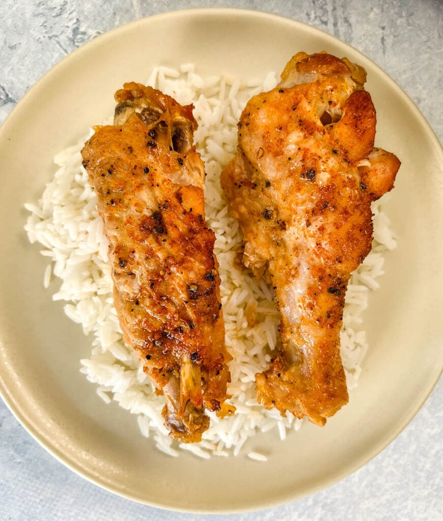 slow cooker turkey wings on a plate with white rice