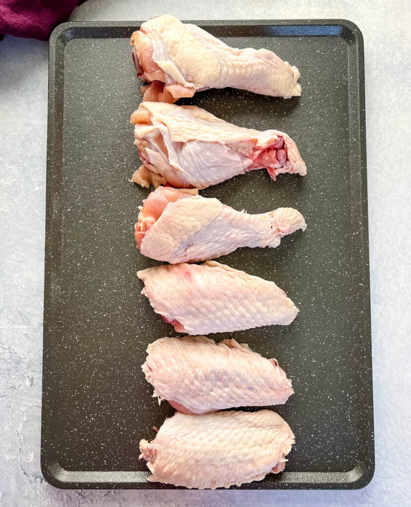 raw split turkey wings on a pan