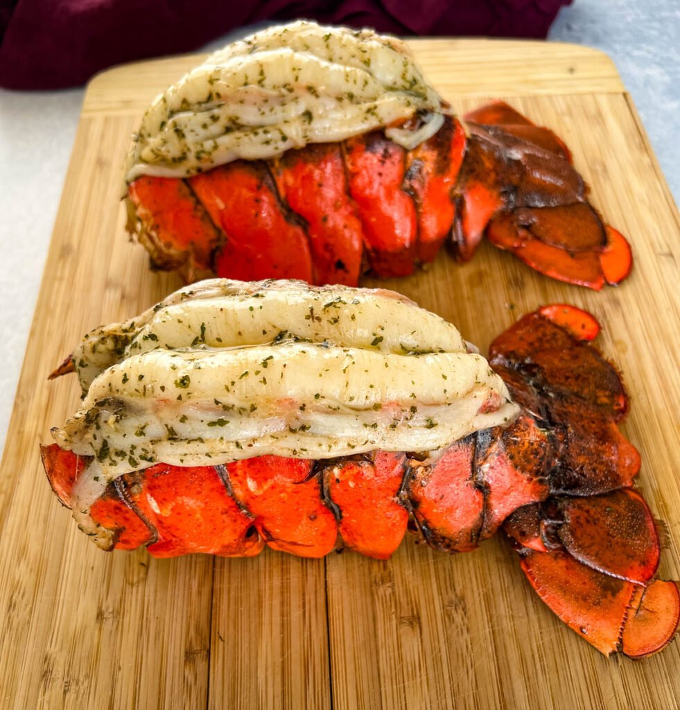 smoked lobster tails on a cutting board
