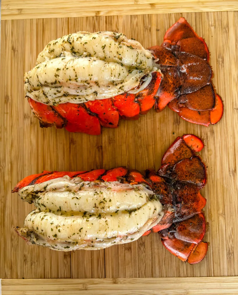 smoked lobster tails on a cutting board