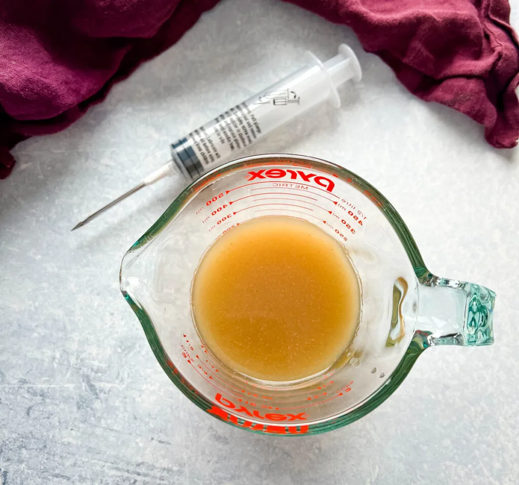 butter marinade injection in a glass cup