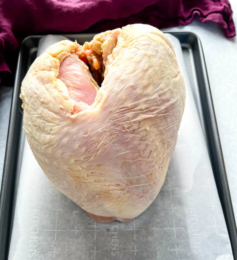 raw turkey breast on parchment paper