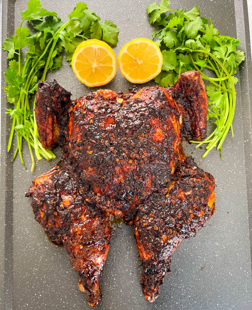 smoked whole chicken on a pan