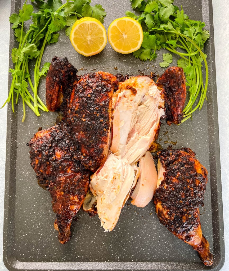 sliced smoked whole chicken on a pan