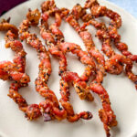 cooked twisted bacon on a plate