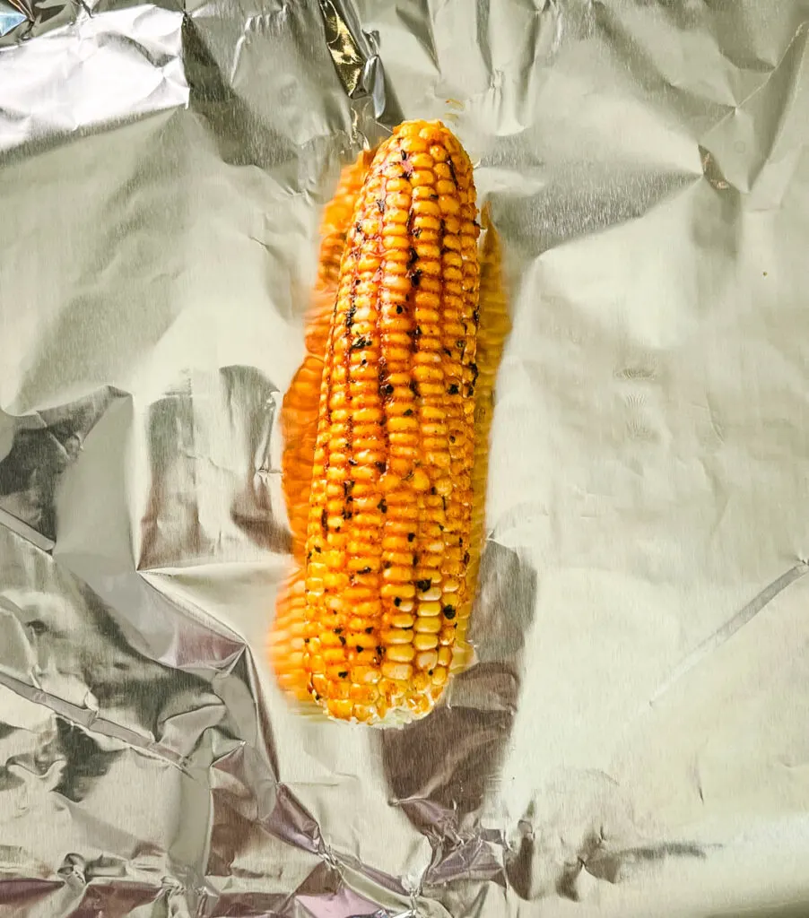 seasoned corn on the cob on foil