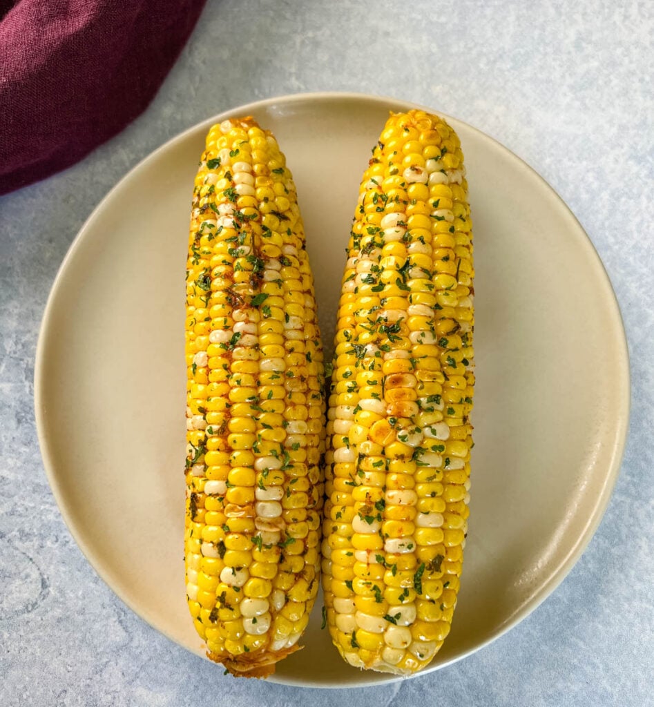 baked oven roasted corn on the cob on a plate