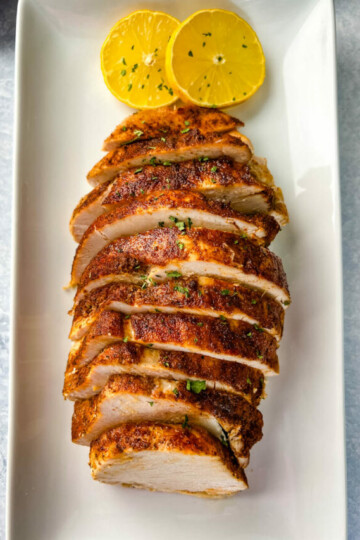 slow cooker Crockpot boneless turkey breast sliced on a white plate