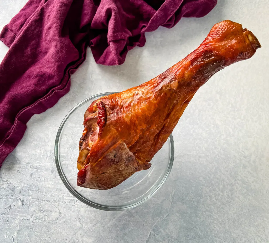 smoked turkey leg in a glass bowl