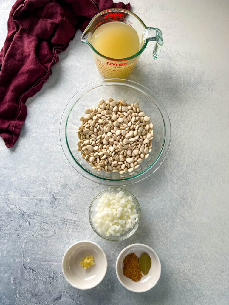 broth, lima beans, onions, garlic, and spices in separate bowls