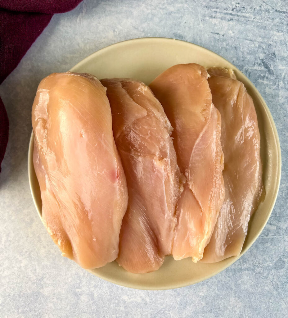 raw chicken breasts on a plate