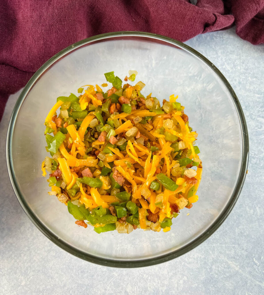 cheese and sauteed vegetables in a glass bowl