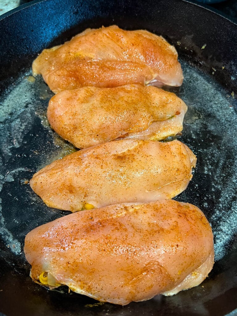 raw stuffed chicken breast in a cast iron skillet