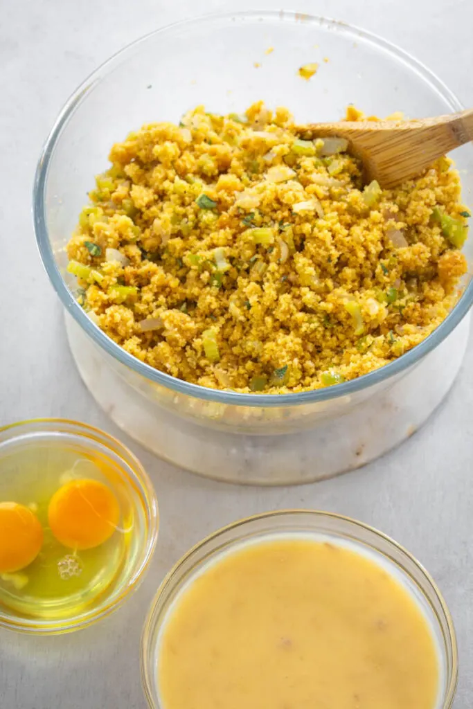 cooked cornbread, raw eggs, and cream of chicken soup in separate bowls