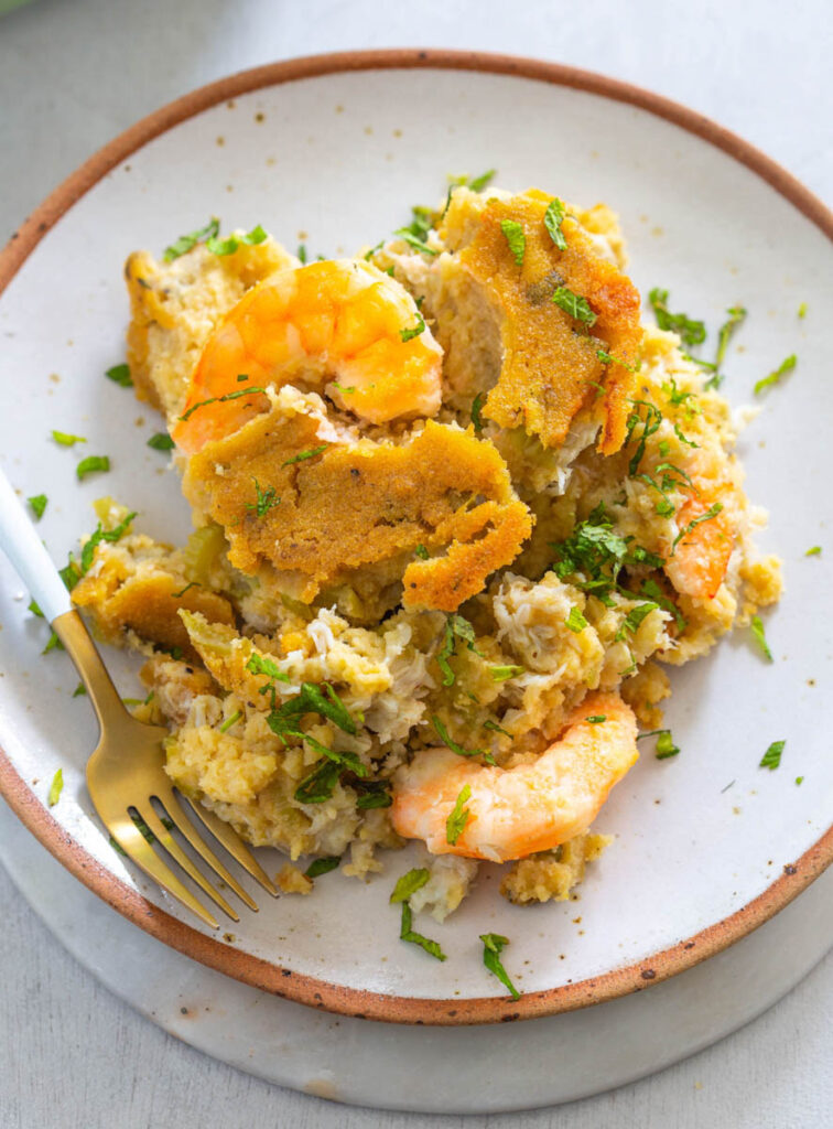 seafood cornbread dressing on a white plate