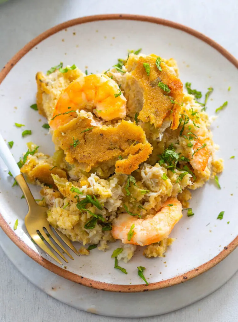 seafood cornbread dressing on a white plate