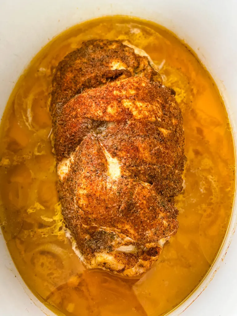 slow cooker boneless turkey breast sliced in a Crockpot