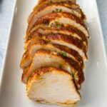 slow cooker Crockpot boneless turkey breast sliced on a white plate